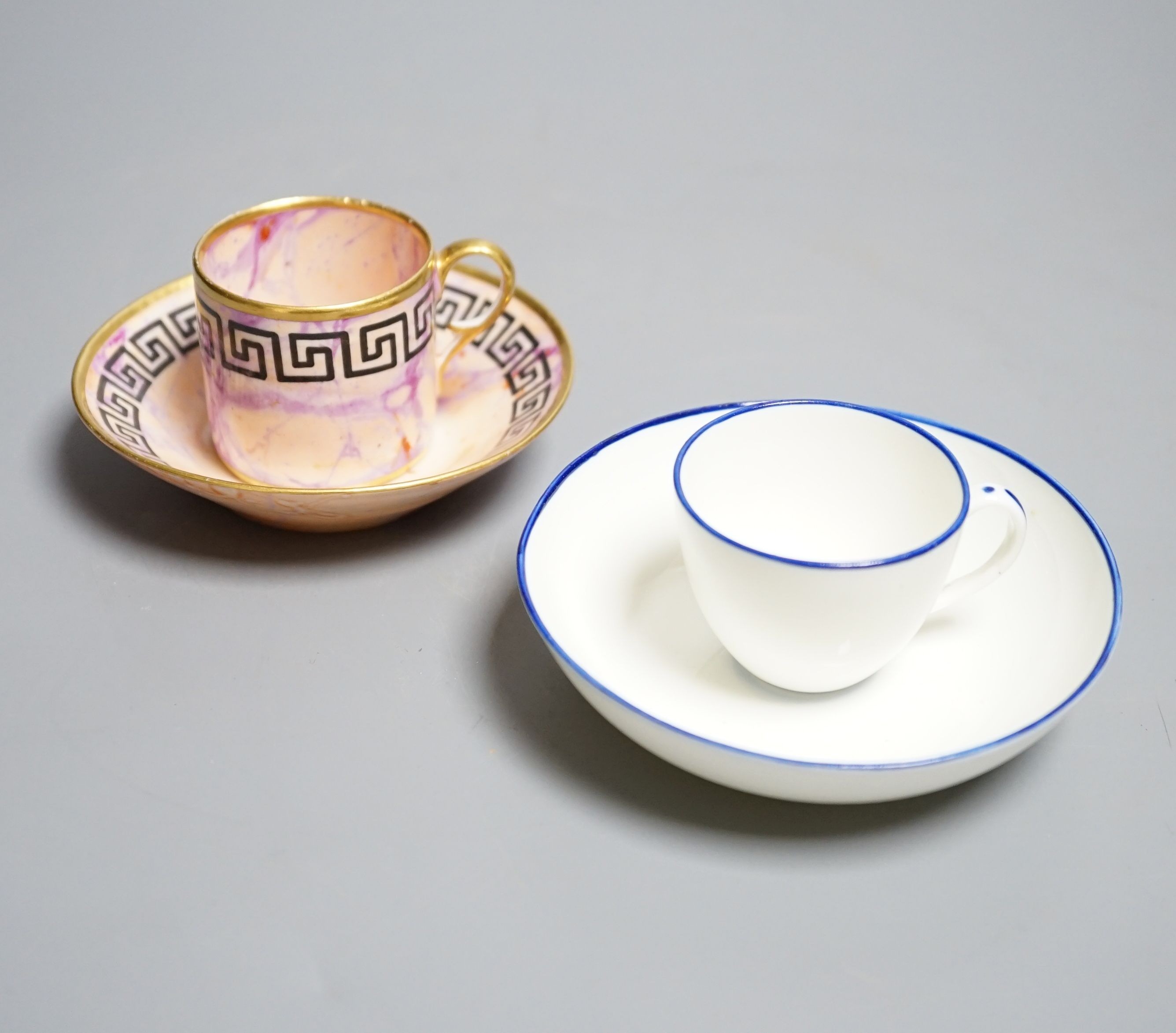 A Derby miniature coffee can and saucer, c.1800-10 and a Pinxton miniature teacup and saucer, c.1800. Provenance - Mona Sattin collection of miniature cups and saucers, collection no.s 112 & 114.